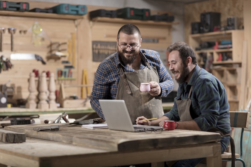 two small business owners viewing a laptop
